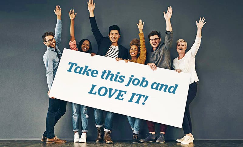 Professionals holding up sign that reads"take this job and love it!"